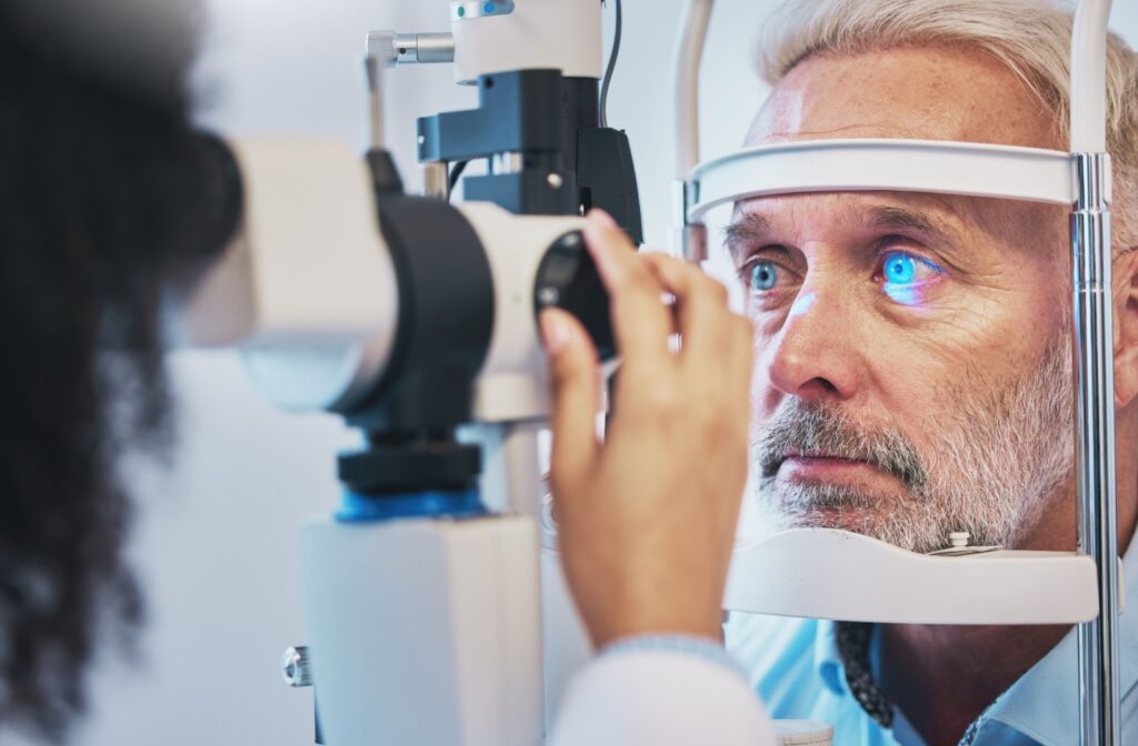 An eye doctor uses a slit lamp to assess a patient's corneal health during a routine eye exam.